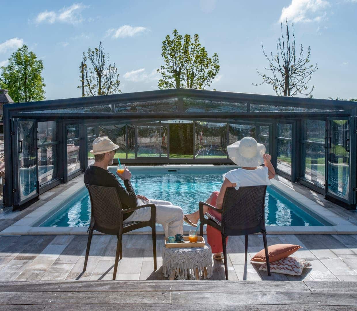 Couple devant un abri de piscine avec du soleil